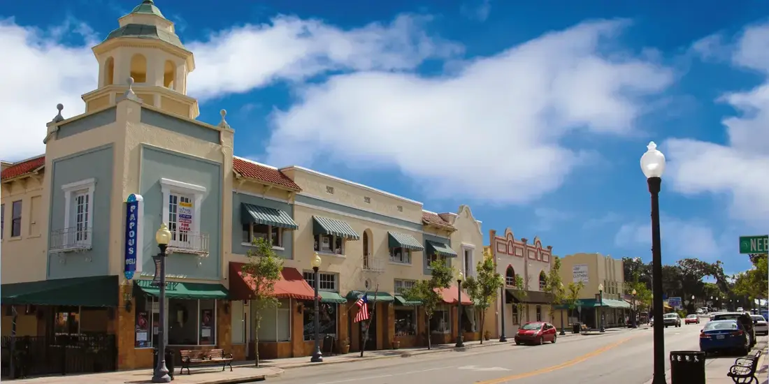 Historic downtown storefronts with awnings and a cupola on a Pasco County main street